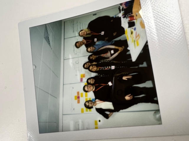 One of the teams formed during the weekend, in front of the working wall.